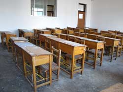 Dong Heng showed me a school in Xin Min where his father worked. Very soon these desks would be replaced and pupils begin their study. By the way, communism is one of the subjects in the schedule.