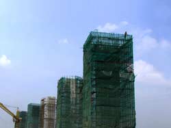Construction works change the face of the country inducing endless movement around. Trucks, workers, concrete and water - everything is involved in it. It bores when you pass it by on a bike, but that's what people call progress.