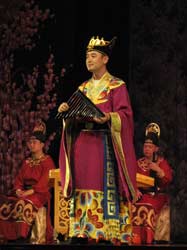 Riding across a busy commercial district, I was attacked by an extremely persistent person whose name was Huan. He spoke English very fluently and persuaded me to buy ... a ticket to an opera.