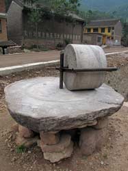 This simple hand-driven mechanism helps mill corn into coarse flour.